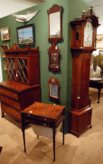 The Federal tall case clock marked David Wood, Newburyport, sold at $9,487, the Federal worktable realized $7,475, the Federal writing desk $1,495, and the Bellamy eagle brought $3,737.