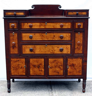 A circa 1825–30 late period Sheraton cherry and mahogany server with dramatic contrasting bird's-eye maple drawer fronts and splash with carved rosettes brought $5,600.