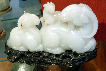 An Eighteenth Century Chinese greenish white jade carving in the form of three rams that sold to a phone bidder for $171,000 was the high lot at Skinner's best Asian arts sale ever. Its elaborately carved ivory stand was stained black.