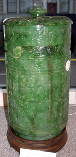 A pair of bright green jade jars with stands was carved with Tao Tieh marks and animal figures and bore the six character Ch'ien Lung mark inlaid with gold. The pair achieved $47,000. 