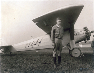 A photo of Charles Lindbergh posing with his plane, Spirit of St Louis, realized $12,670.