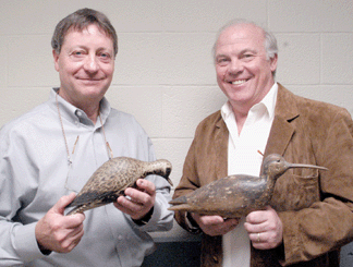 Auction house principals Frank Schmidt, left, and Gary Guyette, with two of the stars from the "lost Mackey collection decoys,” respectively, the A.E. Crowell black bellied plover that established a record price paid at auction for a decoy at $830,000, and the Nathan Cobb curlew that brought $390,000, a record price paid at auction for a Virginia decoy.