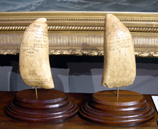 The two scrimshaw teeth engraved aboard the Timoleon by Nantucket whaleman Josiah Shefield Jr served as a log of the ship's 1833 voyage. The two teeth are the only known examples from a set of nine from that voyage and were in the booth of Hyland Granby. Hyannisport, Mass.