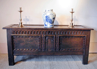 Five-foot English oak coffer used to store clothing and blankets, circa 1660–1680.