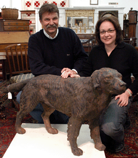 Auctioneer Russ and Abbe Carlsen with the cast iron dog that sold for $7,475. 