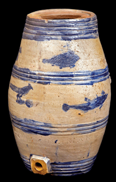 Coolers were designed to dispense liquids from a stationary position, unlike jugs and pitchers, which were meant to be carried and transported. This unusual keg is decorated with incised fish and bird decorations, stamped "PAUL : CUSHMAN'S,” circa 1805–1833.