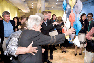 At a private birthday party held November 13 on her 100th birthday at Pratt's Manhattan gallery, Eva Zeisel inspects one of her earlier works, "Prototypes for Modular Ceramic Wall Dividers,” Manifattura Mancioli (Montelupo, Italy), glazed porcelain, 1958.