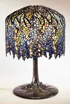 The sinuous lines of the Wisteria lamp that Driscoll designed around 1901 is an example of the undulating forms of several Tiffany patterns. Neustadt Collection. Queens Museum of Art. "From Bud To Blossom: Tiffany's Floral Lamps,” The Queens Museum Of Art.