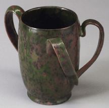 Threehandled cup or tyg by George E Ohr Mottled pink and green glaze Collection of The OhrOKeefe Museum of Art