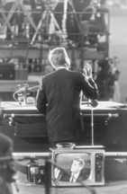 One of the most memorable photographs in the show is Garry Winogrands view from behind of a dramatically lit JFK emphatically delivering his acceptance speech at the 1960 Democratic National Convention in Los Angeles The telegenic candidates image from the front appears on a television seen in the foreground making this a portraitwithinaportrait