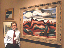 Jim Reinish of Martha Parrish and James Reinish New York City with the Marsden Hartley oil entitled New Mexico Recollection 13