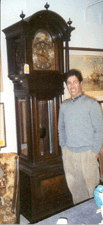 Auctioneer Mitchell Borenstein stands next to a Tiffany amp Co tall case mahogany grandfather clock that sold to Frank and Meg DePasqua of Red Barn Antiques for 12362