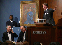 Auctioneer Tobias Meyer acknowledges a bid for Garcon a la Pipe Assisting clients in the foreground are codirectors of the Impressionist and Modern art department at Sothebys David Norman left and Charlie Moffett