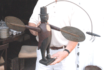 A whirligig of a man in a top hat and tails sold for 6272