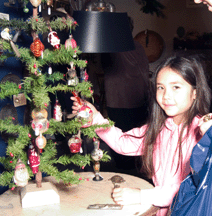In Robert Whitingtons booth Kyra 7 enjoys picking out ornaments
