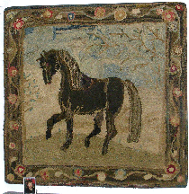 Debra Schaffer an antiques dealer from Maine was showing this early American Nineteenth Century folky hooked rug a prancing horse against a bluegray sky with vines all around