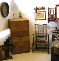 Massachusetts dealer Sue Wirth displayed an early primitive country desk possibly late Eighteenth Century with original bales and dovetailed drawers