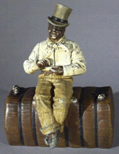 Painted cast iron doorstop featuring a gentleman on a bale of cotton 16500