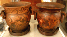 The two Pennsylvania unglazed flowerpots decorated with in floral slip pattern sold at 2750 and 1320