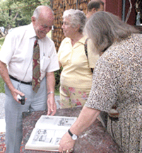 Dick Withington looks over his furniture book with customers