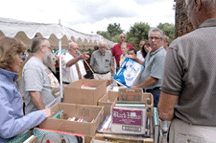 Dick Withington sells the books the oldfashion way gather the crowd around and sell them