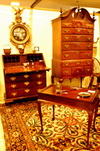 A prime selection of American furniture included the Eastern Massachusetts bonnettop highboy the slant front from the school of Job Townsend and the Queen Anne traytop tea table in the booth of Wayne Pratt Woodbury Conn and Nantucket