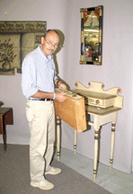 Essex Mass consultant Clark Pearce inspects a rare whitepainted and decorated Sheraton dressing table from a small but choice Midwestern consignment The table sold to Massachusetts dealer David Wheatcroft for 121500 1520000 The table came out of Camden Maine several decades ago before GW Samaha sold it to the consignor Said Wheatcroft Its best of kind It has great height and the paint decoration is done with precision and beauty