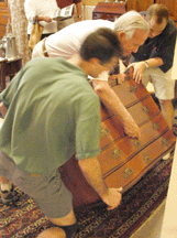 Customers look at top furniture lot serpentine front fourdrawer chest with ball and claw feet 