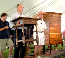 Bill Smith hoists a nice singledrawer stand as Dick Withington elicits bids At the sale Withington recalled several escapades involving Smiths father who had worked for him as a youngster