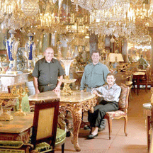 At the French Antique Shop Henry Granet Marc Freidlander and Nicole Granet Freidlander lit by the glow of chandeliers