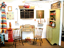 Robin Fernsell of Walpole NH had adjoining booth space with David Beauchamp displaying her art and antiques for the first time at the Okemo show Fernsell specializes in folk art and painted furniture such as the elegant server shown center that was found in Round Pond Maine