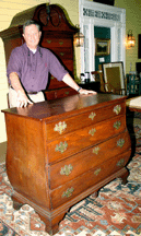 Auctioneer Duane Merrill passed this Massachusetts Chippendale bombe chest of drawers when he couldnt get an opening bid of 10000 There wasnt a reserve I was just doing my fiduciary duty said Merrill who later had several private offers on what appears to be a choice fragment The bottom half of an Eighteenth Century chestonchest has one replaced drawer The New Hampshire Queen Anne maple bonnet top highboy at rear sold in the room for 8250