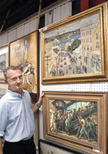 Auctioneer Ron Clarke with the Leon Reiss and Guy Wiggins paintings
