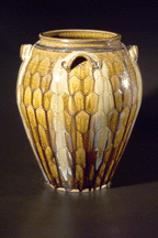 Catawba Valley potter Kim Ellington made a jazzy alkaline glazed jar in 2001 and decorated it with incising and runs from each of the four handles
