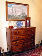Offsetting a Federal period bow front chest of drawers 2295 in the booth of Hobsons Choice Antiques Annapolis Md was a John Moll oil on canvas of the Chesapeake Bay 3950