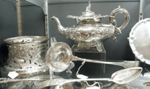 A selection of Irish silver including a profusely decorated teapot circa 1840 in the booth of Silver Plus New York City