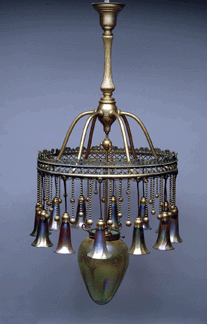 An ornate Tiffany gilt chandelier that featured 12 suspended gold iridescent lily shades complemented by a large central stalactite shade and spiral rope decoration sold for 51750