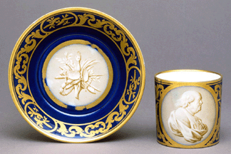 Cup showing portrait of Benjamin Franklin and saucer 1778 painted by NicolasPierre Pithou the Younger gilded by HenriMartin Prvost Hard paste porcelain with enamel and gilt decoration cup 3 by 3 inches saucer 6 inches in diameter
