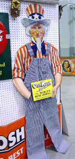 A 1936 OshKosh cardboard Uncle Sam store display with contemporary overalls very similar to the originals produced in 1895 was tagged 900 in Barbara and Matthew Protos booth