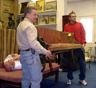 Auctioneer Mike Corcoran lies on the floor as one of his colleagues elicits bids on the Sheraton sofa that realized 6042 without the auctioneers assistance It went to a phone bidder who couldnt see how the auction was unraveling