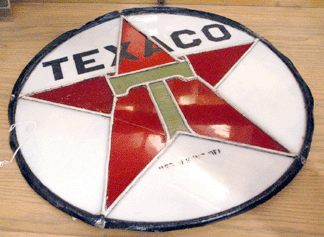 The round leaded glass window insert with the Texaco star was bid to 1430