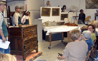 Auctioneer Michael Fallon takes bids on the rare Pilgrim chest