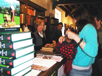 MaryRose Brooks a 20year employee of Booths Books and John Richard a relative newcomer of eight years serve customers as a younger Richard Booth peers out from the cover of his autobiography My Kingdom of Books