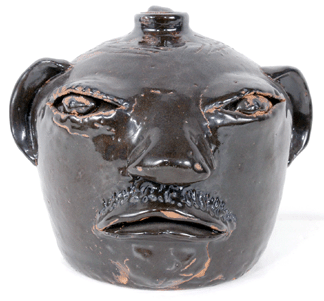 This rare brown glaze face jug crafted around 1970 by the renowned folk artist Arie Meaders realized 9660