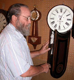 Joe Williams of Oakboro NC inspecting a 28 12inchhigh E Howard 5 banjo with original interior directions label in the bottom of the door The finish the dial and pendulum were in original condition Estimated at 8001200 the clock brought 4500 and went to California