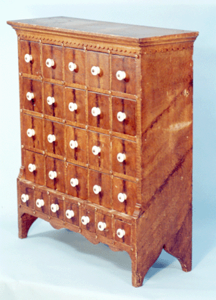Seed chest with flat-top attributed to John Palm Boyer, Brickerville, Penn. Note the applied scalloped fascia and button decoration around the drawers. Height, 23 inches. Private collection.