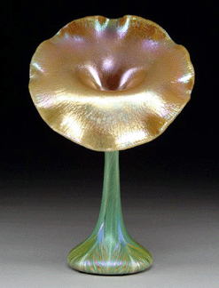 A Quezal jack-in-the-pulpit vase with green pulled feather design brought $36,800, considerably above its $3/5,000 estimate.