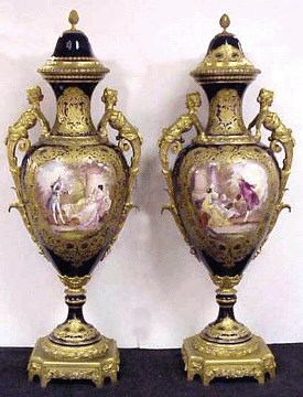 A pair of Sevres cobalt palace urns with hand painted landscape and genre scenes grossed $63,250.