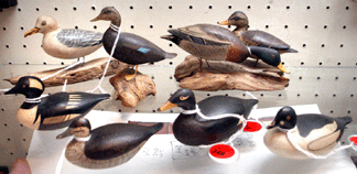 A selection of miniatures by Lincoln brought strong prices with a miniature hooded merganser, left center, topping the group at $8,625. Other Lincoln miniatures included, bottom row from left, a miniature ruddy duck in winter plumage, $4,887, a white wing scoter selling at $5,462, and a miniature goldeneye drake that brought $3,450.