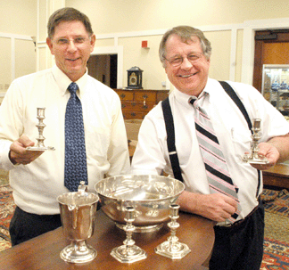 Julia's Americana specialist Bill Gage, left, and auctioneer Jim Julia with the prizes from the silver that was sold. The candlesticks realized $106,375, the ewer $54,050 and the bowl $97,750.
